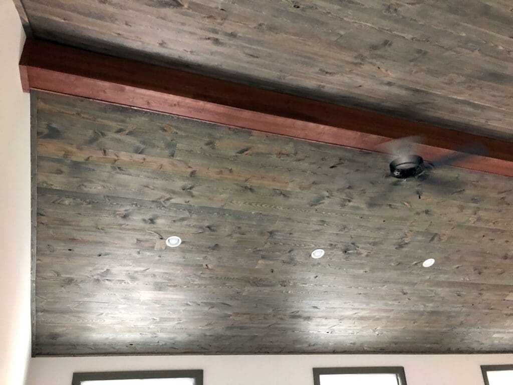 View of stylish wooden interior ceiling with a central beam from custom millwork running the length of the room at its peak