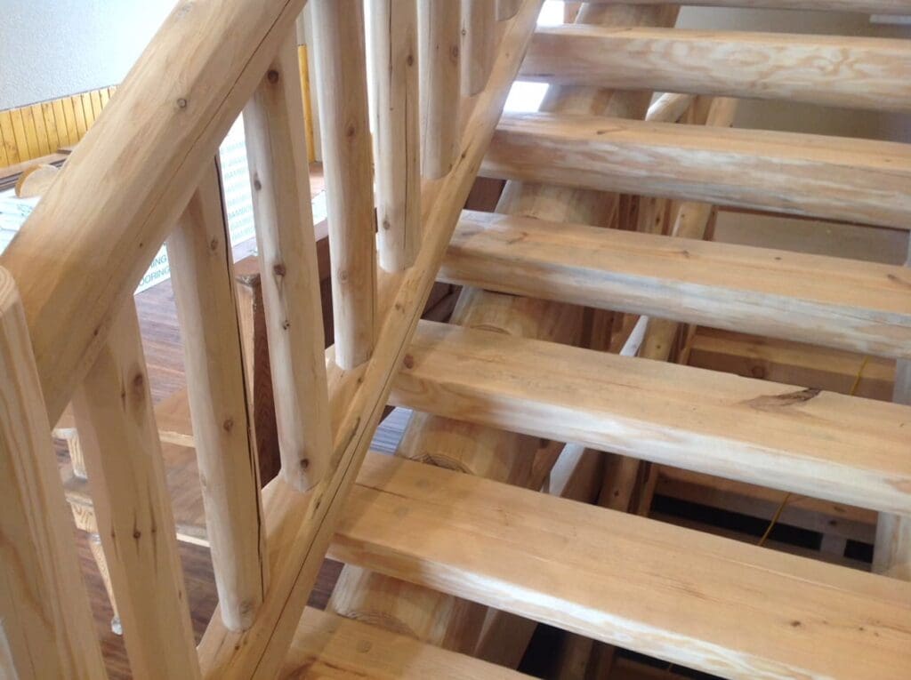 A closer view of the wooden staircase that reveals knots and millwork quirks that creates character in any lumber project