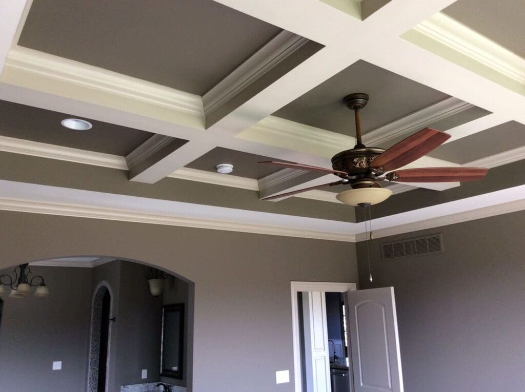 Light decorative beams form square shapes across a darker ceiling.
