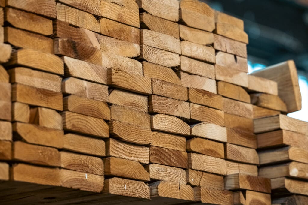 A Machinery Warehouse With Stacked Wood Organized And Ready For Commercial Construction Use